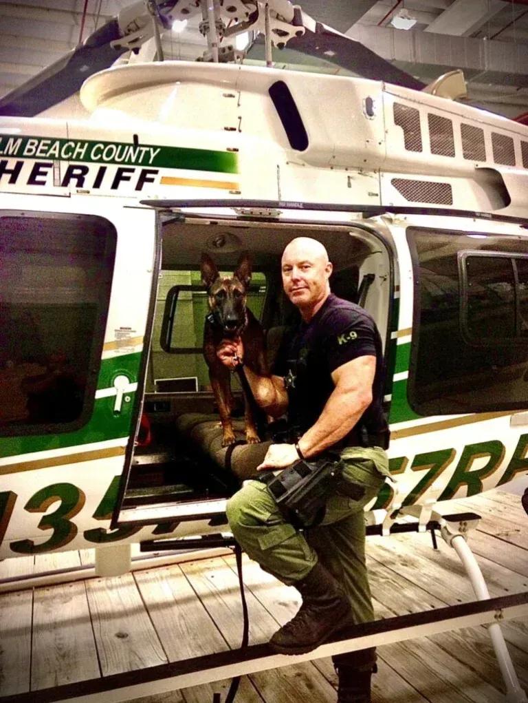 Knoxville trainer Justin Rigney with a police K9 at a sheriff's helicopter, police K9 training experience