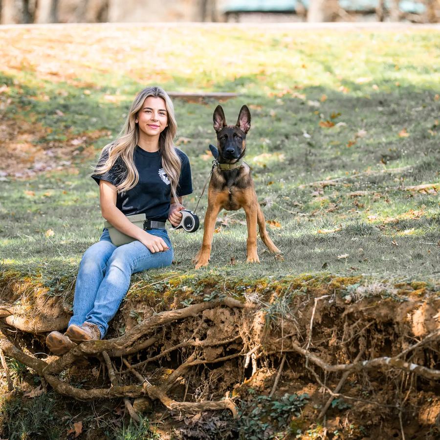 Rebeka sitting with a Belgian Malinois